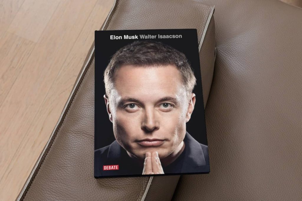 Copy of the book 'Elon Musk' by Walter Isaacson resting on a lounge chair